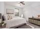 Spacious bedroom with a dresser, queen bed and window coverings at 14104 W Bronco Trl, Surprise, AZ 85387