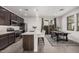 Modern kitchen with dark cabinetry, stainless steel appliances and an island at 14104 W Bronco Trl, Surprise, AZ 85387