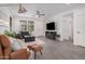 Bright and airy living room featuring a sectional sofa and fireplace at 14104 W Bronco Trl, Surprise, AZ 85387