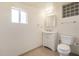 Bathroom with toilet, vanity, and block window at 1416 S Lawther Dr, Apache Junction, AZ 85120