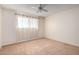 Spacious bedroom with ceiling fan and neutral carpet at 1416 S Lawther Dr, Apache Junction, AZ 85120