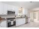 Modern kitchen with white cabinets and stainless steel appliances at 1416 S Lawther Dr, Apache Junction, AZ 85120