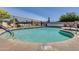 Community swimming pool with surrounding chairs at 1416 S Lawther Dr, Apache Junction, AZ 85120