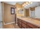 Bathroom with double sinks and dark wood cabinets at 16118 W Gibson Ln, Goodyear, AZ 85338