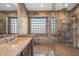 Spa-like bathroom featuring a walk-in shower and glass block window at 16118 W Gibson Ln, Goodyear, AZ 85338