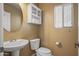 Small bathroom with pedestal sink and built-in shelving at 16118 W Gibson Ln, Goodyear, AZ 85338