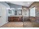 Elegant bathroom with double sinks, large shower, and tile flooring at 16118 W Gibson Ln, Goodyear, AZ 85338