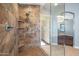 Modern bathroom with a large walk-in shower and glass enclosure at 16118 W Gibson Ln, Goodyear, AZ 85338