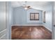 Light and bright bedroom featuring hardwood floors and a ceiling fan at 16118 W Gibson Ln, Goodyear, AZ 85338