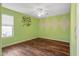 Charming bedroom with hardwood floors and green walls at 16118 W Gibson Ln, Goodyear, AZ 85338