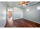 Bright bedroom with hardwood floors and ceiling fan at 16118 W Gibson Ln, Goodyear, AZ 85338