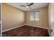 Simple bedroom with hardwood floors and a ceiling fan at 16118 W Gibson Ln, Goodyear, AZ 85338