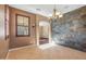 Dining room features a stone accent wall and an arched entryway at 16118 W Gibson Ln, Goodyear, AZ 85338