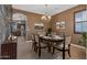 Formal dining room with a chandelier and stone accent wall at 16118 W Gibson Ln, Goodyear, AZ 85338