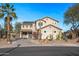 Two-story house with desert landscaping and a large driveway at 16118 W Gibson Ln, Goodyear, AZ 85338