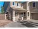 Two-story house with tan exterior, and a two-car garage at 16118 W Gibson Ln, Goodyear, AZ 85338