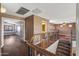 Upstairs hallway with hardwood floors, leading to bedrooms and bathroom at 16118 W Gibson Ln, Goodyear, AZ 85338