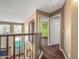 Upstairs hallway with wood floors and access to bedrooms at 16118 W Gibson Ln, Goodyear, AZ 85338