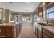 Bright kitchen with an island and view into the adjacent dining area at 16118 W Gibson Ln, Goodyear, AZ 85338