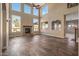 High-ceiling living room with stone fireplace and hardwood floors at 16118 W Gibson Ln, Goodyear, AZ 85338