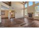 High-ceiling living room with stone fireplace and hardwood floors at 16118 W Gibson Ln, Goodyear, AZ 85338