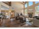 High-ceiling living room with stone fireplace and hardwood floors at 16118 W Gibson Ln, Goodyear, AZ 85338