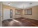 Bright living room featuring hardwood floors and large windows at 16118 W Gibson Ln, Goodyear, AZ 85338