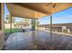 Covered patio with tile flooring, overlooking the pool and spa at 16118 W Gibson Ln, Goodyear, AZ 85338