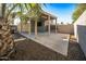 Covered patio with concrete flooring adjacent to storage shed at 16118 W Gibson Ln, Goodyear, AZ 85338