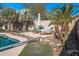 Relaxing poolside space with lounge chairs and umbrella at 16118 W Gibson Ln, Goodyear, AZ 85338