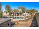 Inviting kidney-shaped pool with surrounding landscaping at 16118 W Gibson Ln, Goodyear, AZ 85338