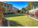 Landscaped backyard with artificial putting green at 16118 W Gibson Ln, Goodyear, AZ 85338