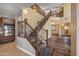 Elegant staircase with wrought iron railing and wood steps at 16118 W Gibson Ln, Goodyear, AZ 85338