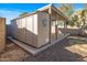 Tan colored storage shed with covered patio area at 16118 W Gibson Ln, Goodyear, AZ 85338