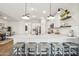 Kitchen island with seating for four and a large quartz countertop at 16530 N Dante Way, Maricopa, AZ 85138