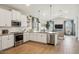 Modern kitchen with white cabinets and stainless steel appliances at 16530 N Dante Way, Maricopa, AZ 85138