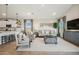 Open-concept living room with kitchen island partially visible at 16530 N Dante Way, Maricopa, AZ 85138