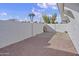 Gravel backyard with a small gate and a large wall at 1703 E Laguna Dr, Tempe, AZ 85282