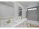 Bathroom with double vanity, marble countertops, and gold fixtures at 1703 E Laguna Dr, Tempe, AZ 85282