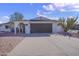 White single story home with a dark brown garage door and a neatly landscaped yard at 1703 E Laguna Dr, Tempe, AZ 85282