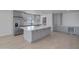 Modern kitchen with gray cabinets, marble island, and stainless steel appliances at 1703 E Laguna Dr, Tempe, AZ 85282