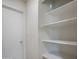 White pantry with ample shelving for storage at 1703 E Laguna Dr, Tempe, AZ 85282