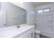 Clean bathroom with gray flooring, white vanity, and a shower-tub combo with white tile surround at 17469 N 66Th Ave, Glendale, AZ 85308