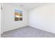 Bright bedroom with gray flooring, large window with natural light, and white walls at 17469 N 66Th Ave, Glendale, AZ 85308