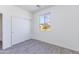 Bright bedroom with gray flooring, closet with sliding doors, and large window with natural light at 17469 N 66Th Ave, Glendale, AZ 85308