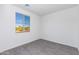 Bright bedroom featuring gray flooring, a large window with natural light, and white walls at 17469 N 66Th Ave, Glendale, AZ 85308