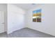 Bright bedroom with gray flooring, closet with sliding doors, and large window with natural light at 17469 N 66Th Ave, Glendale, AZ 85308