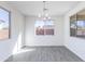 Bright dining room with large windows and modern chandelier fixture at 17469 N 66Th Ave, Glendale, AZ 85308