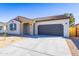 Charming single-story home featuring a two-car garage, desert landscaping, and covered entrance at 17469 N 66Th Ave, Glendale, AZ 85308