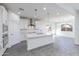 Well-lit kitchen featuring island, stainless steel hood, and view to living area at 17469 N 66Th Ave, Glendale, AZ 85308